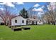 Expansive backyard featuring a lush green lawn, mature trees, and raised garden beds for gardening enthusiasts at 7859 Jennifer Ln, Brownsburg, IN 46112
