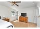 Comfortable bedroom with wood floors, a ceiling fan, and a large window at 7859 Jennifer Ln, Brownsburg, IN 46112