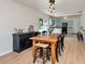 Open-concept dining room featuring a view of the kitchen, wood floors, and natural light at 7859 Jennifer Ln, Brownsburg, IN 46112