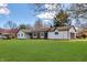 Beautifully landscaped ranch-style home with a spacious lawn and a two-car garage on a sunny day at 7859 Jennifer Ln, Brownsburg, IN 46112