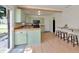 Bright kitchen featuring wooden countertops, sage-green cabinets, bar seating, and stainless steel appliances at 7859 Jennifer Ln, Brownsburg, IN 46112