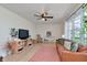 Bright living room with modern decor, hardwood floors, and a comfortable brown leather couch at 7859 Jennifer Ln, Brownsburg, IN 46112