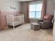 A neutral Bedroom with a white crib, rocking chair and ottoman at 796 Booneway Ln, Bargersville, IN 46106