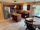 Well-lit kitchen showcases modern appliances, cherry cabinetry, and functional island at 796 Booneway Ln, Bargersville, IN 46106