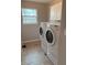 A laundry room with white washer and dryer and built-in cabinets at 796 Booneway Ln, Bargersville, IN 46106