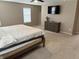 Bright main bedroom with large windows, plush carpet, a ceiling fan and a dresser with a TV at 796 Booneway Ln, Bargersville, IN 46106