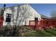 Backyard featuring a vibrant red deck, verdant lawn, and siding, creating a delightful outdoor haven at 8219 Lake Tree Ln, Indianapolis, IN 46217