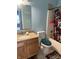 Bathroom features a wooden vanity, toilet, shower, and tub, offering a functional space at 8219 Lake Tree Ln, Indianapolis, IN 46217