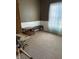Bedroom with neutral carpet, wood trim, a sunny window and furniture, perfect for rest and relaxation at 8219 Lake Tree Ln, Indianapolis, IN 46217