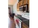 Efficient kitchen with stainless steel microwave and an electric stove at 8219 Lake Tree Ln, Indianapolis, IN 46217