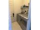 Laundry room featuring stainless steel washer and dryer, offering convenience and efficiency at 8219 Lake Tree Ln, Indianapolis, IN 46217