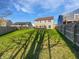 Lush backyard featuring a sprawling green lawn, a deck, and a wood fence, perfect for outdoor activities at 8251 Garden Ridge Rd, Indianapolis, IN 46237