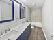 Stylish bathroom with double vanity, marble countertop, and shower over tub at 8251 Garden Ridge Rd, Indianapolis, IN 46237
