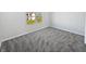 Bright bedroom with plush carpeting and a large window offering neighborhood views at 8251 Garden Ridge Rd, Indianapolis, IN 46237