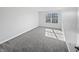 Minimalist bedroom with a bright window and plush carpeting, ideal for relaxation and comfort at 8251 Garden Ridge Rd, Indianapolis, IN 46237