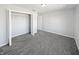 Clean bedroom with bi-fold closet doors, neutral paint, and plush carpeting at 8251 Garden Ridge Rd, Indianapolis, IN 46237