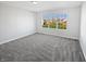 Sun-drenched bedroom features plush carpeting and a large window showcasing a lush green yard at 8251 Garden Ridge Rd, Indianapolis, IN 46237