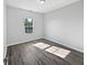 Bedroom featuring hardwood floors and a window providing natural light at 8251 Garden Ridge Rd, Indianapolis, IN 46237
