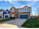 Exterior view of a two-story home with a two-car garage, well-maintained lawn, and a clear, sunny sky at 8251 Garden Ridge Rd, Indianapolis, IN 46237