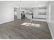 Bright, open-concept living space showcasing hardwood-style flooring and a well-lit, modern kitchen at 8251 Garden Ridge Rd, Indianapolis, IN 46237