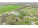 Scenic aerial view of a property with a large pond, surrounded by lush fields and picturesque landscape at 8394 S 600 W, Pendleton, IN 46064