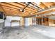 Unfinished basement space showing exposed ceiling, a workbench area, and ample room for storage and customization at 8394 S 600 W, Pendleton, IN 46064