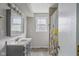The bathroom has a gray vanity, an enclosed shower with a floral curtain, and modern fixtures at 8394 S 600 W, Pendleton, IN 46064