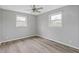 This bedroom has hardwood floors and natural lighting from the large window with white trim at 8394 S 600 W, Pendleton, IN 46064