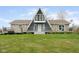 A-frame home featuring a stone facade, a large deck, and a well-manicured lawn at 8394 S 600 W, Pendleton, IN 46064
