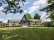 Attractive A-frame home with stone accents, a well-manicured lawn, and inviting front deck perfect for outdoor relaxation at 8394 S 600 W, Pendleton, IN 46064