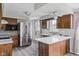 Updated kitchen with stainless steel refrigerator, ample cabinet space, and large island with quartz countertop at 8394 S 600 W, Pendleton, IN 46064