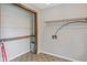 Laundry room with built-in shelves, washer and dryer hookups, and gray tile flooring at 8394 S 600 W, Pendleton, IN 46064