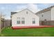 A backyard features a home with white siding, a red deck, green lawn, and wooden privacy fence at 8529 Sansa St, Camby, IN 46113