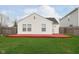 Exterior backyard view of home with white siding, green lawn, red deck and wood privacy fence at 8529 Sansa St, Camby, IN 46113
