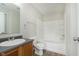 Cozy bathroom featuring a tub-shower combo, wood vanity, and laminate floors at 8529 Sansa St, Camby, IN 46113