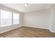 Serene bedroom offering wood-look flooring, natural light, and a cozy ambiance for relaxation and rest at 8529 Sansa St, Camby, IN 46113