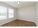 Bright, airy bedroom with wood-look flooring and two large windows offering ample natural light at 8529 Sansa St, Camby, IN 46113