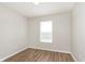 Bright bedroom with wood-look flooring, natural light from the window, and fresh neutral paint at 8529 Sansa St, Camby, IN 46113