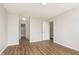 Bright bedroom features wood-look flooring and neutral paint, adjacent to a bathroom at 8529 Sansa St, Camby, IN 46113
