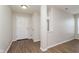 Bright entryway featuring wood-look flooring, neutral paint, and a view into adjacent rooms at 8529 Sansa St, Camby, IN 46113