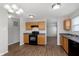Open kitchen layout with wood cabinets, modern appliances, and seamless flow into the dining area at 8529 Sansa St, Camby, IN 46113