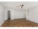 Bright living room showcasing wood-look floors, neutral paint, and a glimpse into adjacent rooms at 8529 Sansa St, Camby, IN 46113