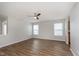 Spacious living room with wood-look flooring, neutral walls, and multiple windows for natural light at 8529 Sansa St, Camby, IN 46113