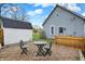 Backyard view of the home featuring a brick patio, shed, and fenced yard at 922 Cottage Ave, Indianapolis, IN 46203