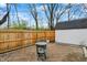 Backyard brick patio with mature trees and storage shed in fenced yard at 922 Cottage Ave, Indianapolis, IN 46203