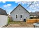 Backyard view of the home featuring a brick patio, shed, and fenced yard at 922 Cottage Ave, Indianapolis, IN 46203