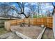 Brick patio in fenced backyard with wooden fencing and a mature shade tree at 922 Cottage Ave, Indianapolis, IN 46203