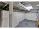 View of the unfinished basement with concrete floor and painted block walls at 922 Cottage Ave, Indianapolis, IN 46203