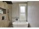 Modern bathroom featuring a soaking tub, rain shower, and sleek fixtures, providing a relaxing and stylish space at 922 Cottage Ave, Indianapolis, IN 46203