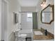 Well-lit bathroom with a vanity, mirror, and shower-tub combo, providing a functional and stylish space at 922 Cottage Ave, Indianapolis, IN 46203